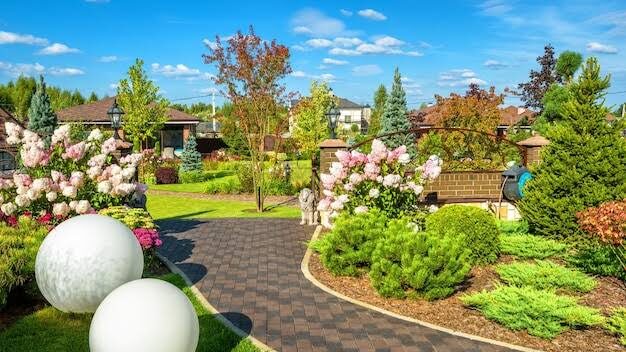 Garden path with globe lights and blooming hydrangeas